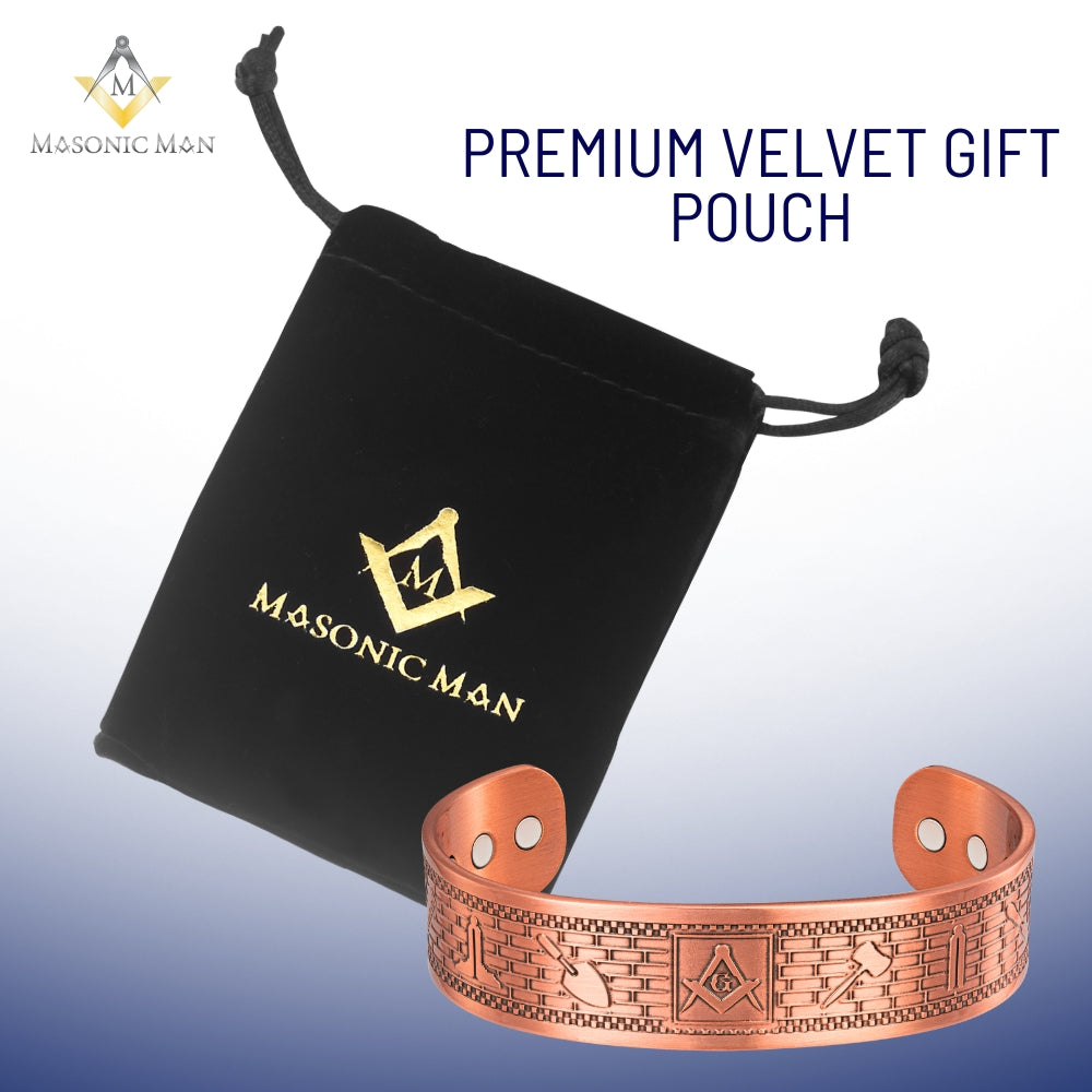 Close-up of copper bracelet showing gavel, plumb, level, chisel, and trowel engravings